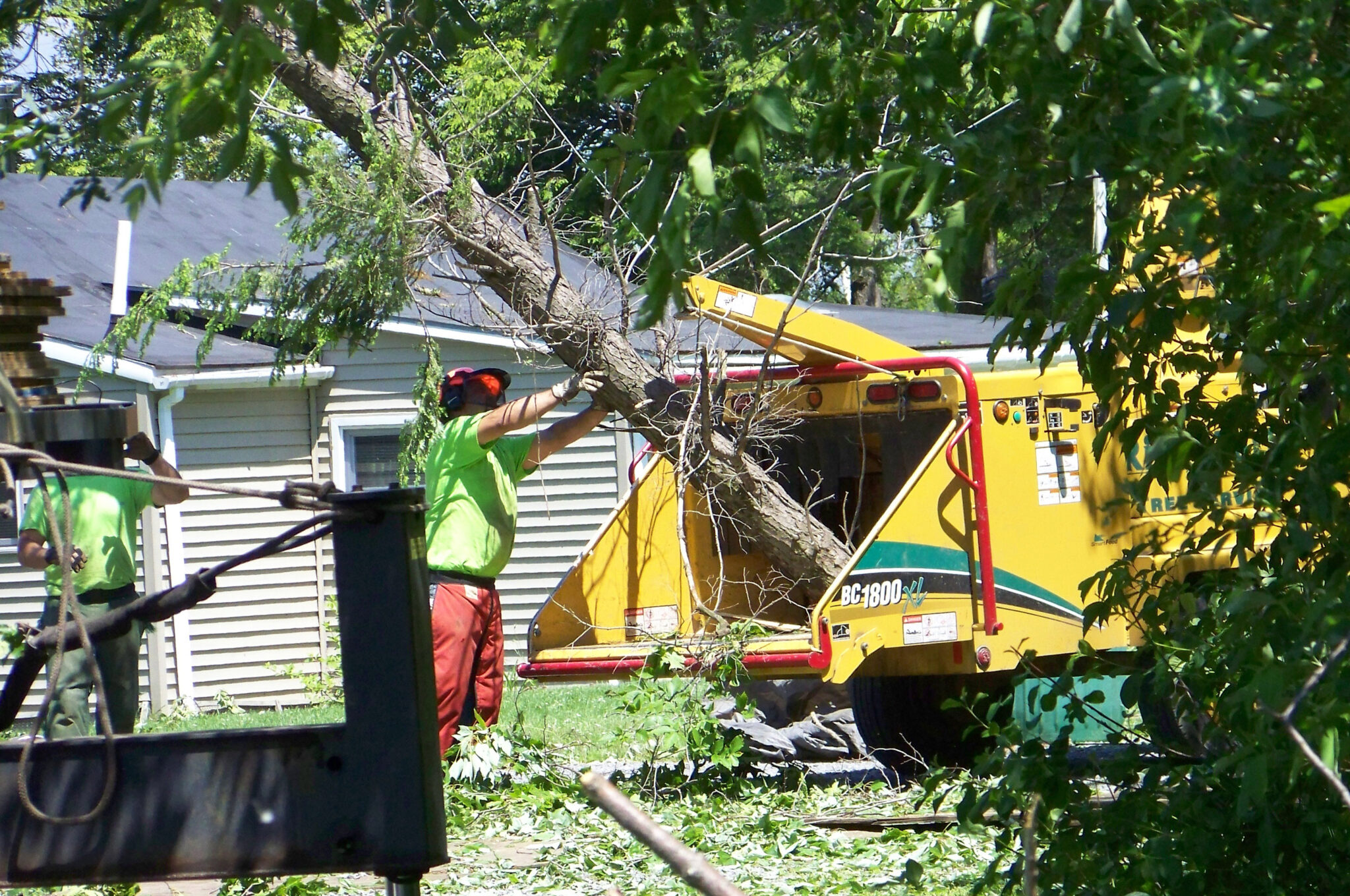 Rick Turk Tree Service crane and bucket truck at work